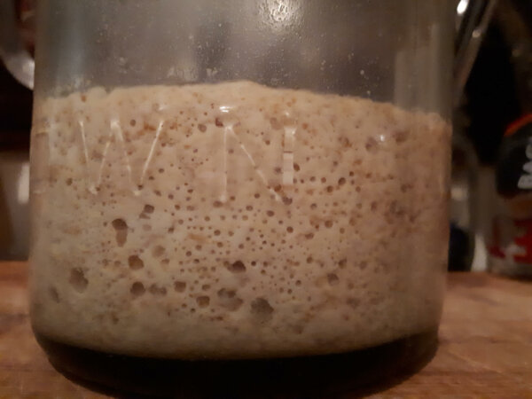 mason jar with bubbly sourdough starter