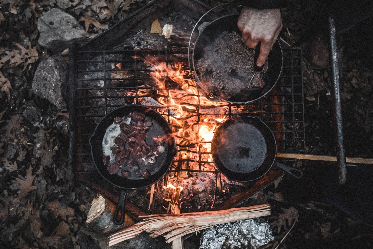 camping on a dutch oven over fire